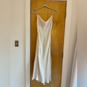 White Zara slip dress with cowl neck and button pattern along slit